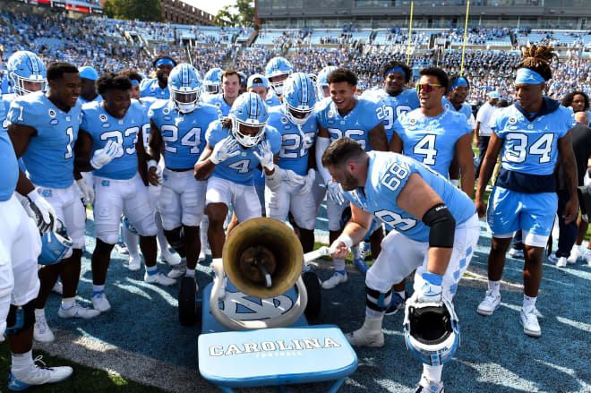 UNC players celebrate with the Victory Bell after beating Duke last season. 
