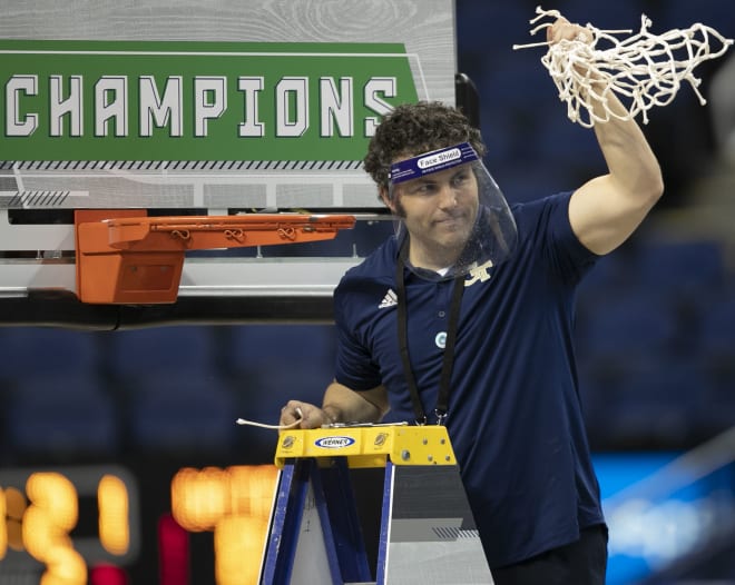 Pastner cutting down the net after the game