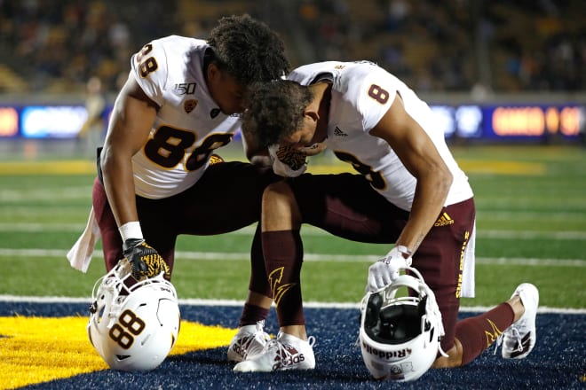 Nolan Matthews (left) and Jordan Kerley kneel before the start of a game against Cal in 2019.