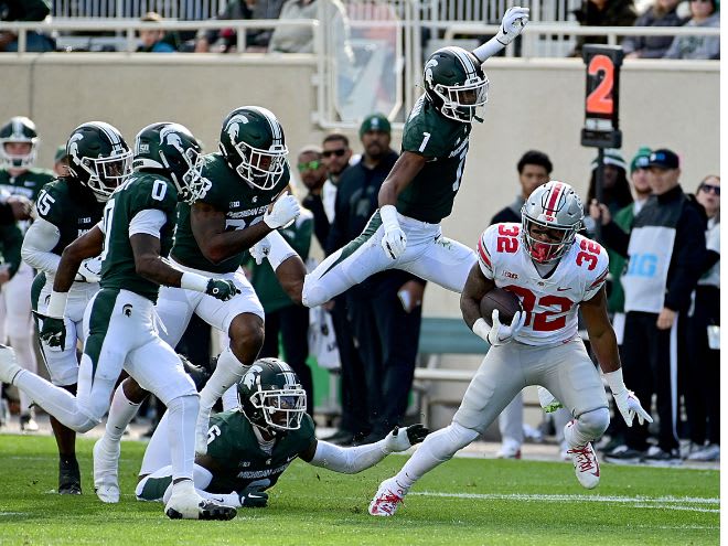Ohio State running back TreVeyon Henderson runs the ball against the Michigan State defense on Oct. 8, 2022. 