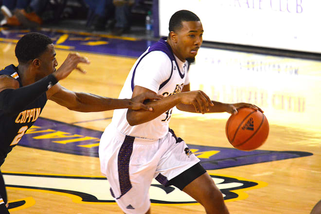 ECU center Charles Coleman drives past Coppin State's Kamar McKnight in Tuesday night's game in Greenville.