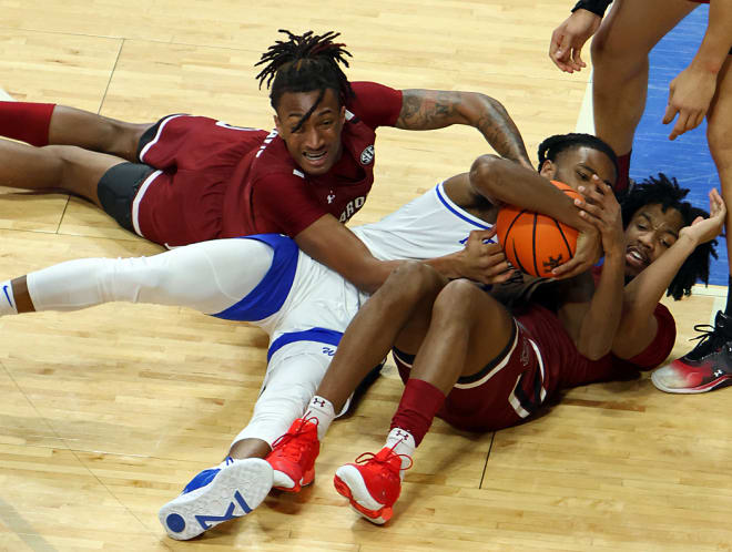 Kentucky's Cason Wallace battled for a loose ball with a pair of South Carolina players during Tuesday's game at Rupp Arena.