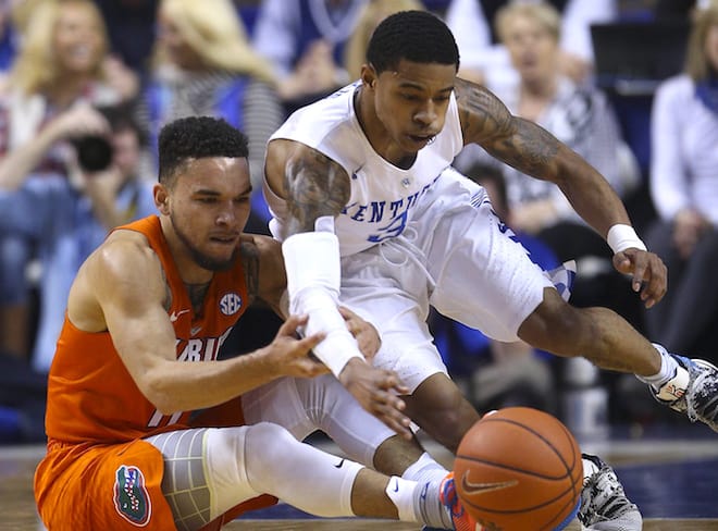 Florida Gators guard Chris Chiozza (11) and Kentucky Wildcats guard Tyler Ulis (3) reach for a loose ball in the first half at Rupp Arena on Saturday.