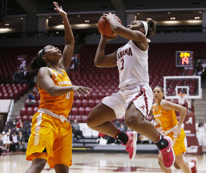 Alabama's Jordan Lewis (3) shoots the ball guarded by Tennessee's Jordan Reynolds (0) during the first half of a game at Coleman Coliseum in Tuscaloosa on Thursday. Alabama won, 65-57. 
