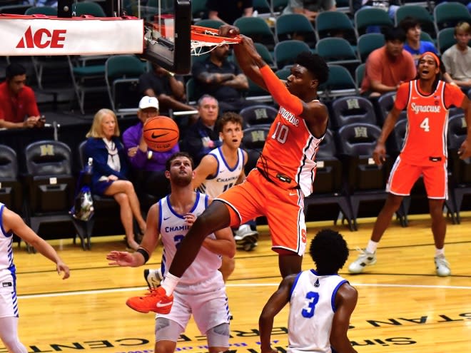 Nov 22, 2023; Honolulu, HI, USA; Syracuse Orange center Naheem McLeod (10) dunks the ball between defenders Chaminade Silverswords forward Wyatt Lowell (25) and forward Chris Bready (3) during the first period at SimpliFi Arena at Stan Sheriff Center. Mandatory Credit: Steven Erler-USA TODAY Sports