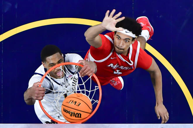 Notre Dame forward Tae Davis (13) dunks in front of Marist's Jackson Price (4) in the second half of an Irish home victory on Friday night.