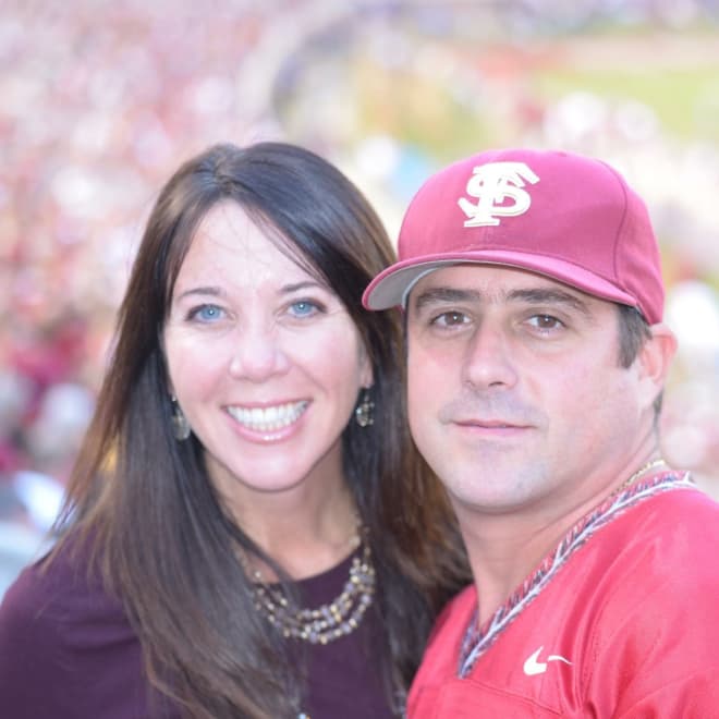 Bradley Deanda poses at an FSU game with his wife, Sharla.