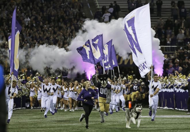 Dubs II, the Washington Huskies live mascot, leads the team out of the tunnel for an NCAA college football game against Arizona State, Saturday, Sept. 22, 2018, in Seattle. (AP Photo/Ted S. Warren)