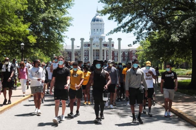 Beyah Rasool with the Mizzou football team, walking to register to vote. 