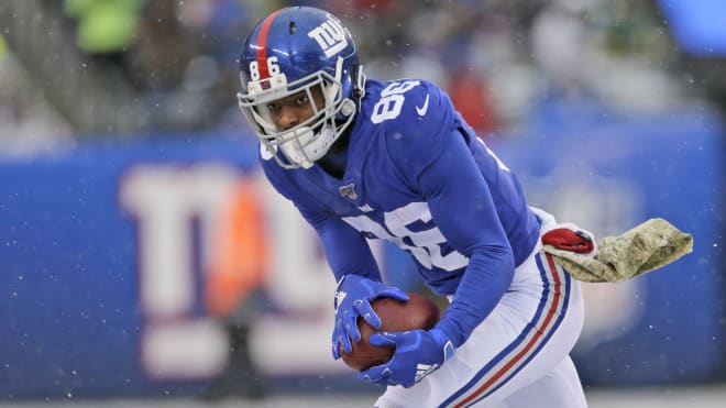 Darius Slayton (86) snags a pass during a snowy Giants game in 2019.