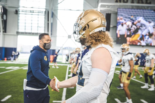 Notre Dame Fighting Irish football defensive coordinator Marcus Freeman with senior linebacker Bo Bauer