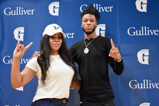 Nealy's mom dons the USF cap at Nealy's signing with USF last December 