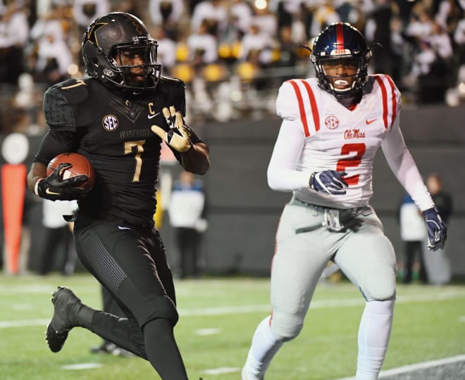 Vanderbilt's Ralph Webb rushes for a touchdown while Ole Miss safety Deontay Anderson chases during Saturday's game in Nashville. Webb scored three touchdowns in the Commodores' win.