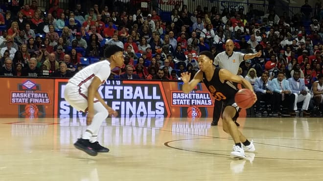 Marion's Makyi Boyce guards Hall's Johnathan Coleman late in the 5A state title game. The Patriots won the contest 57-54 in overtime.