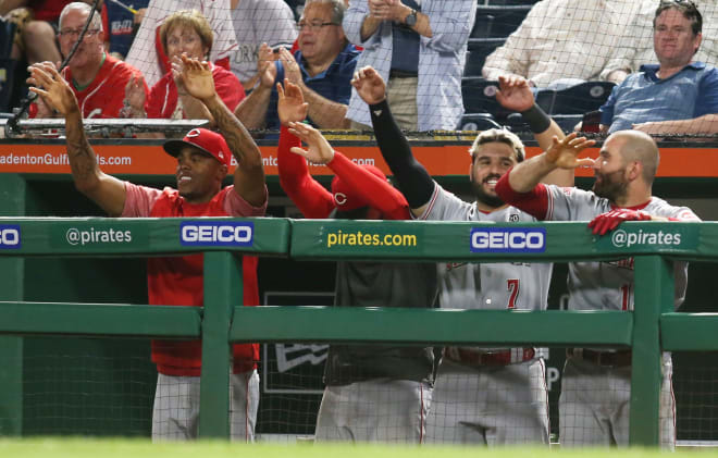 Cincinnati Reds players (left to right) relief pitcher Raisel Iglesias (26) and infielder Jose Peraza (9) and third baseman Eugenio Suarez (7) and first baseman Joey Votto (19) react after he Reds take the lead during the twelfth inning at PNC Park last September.