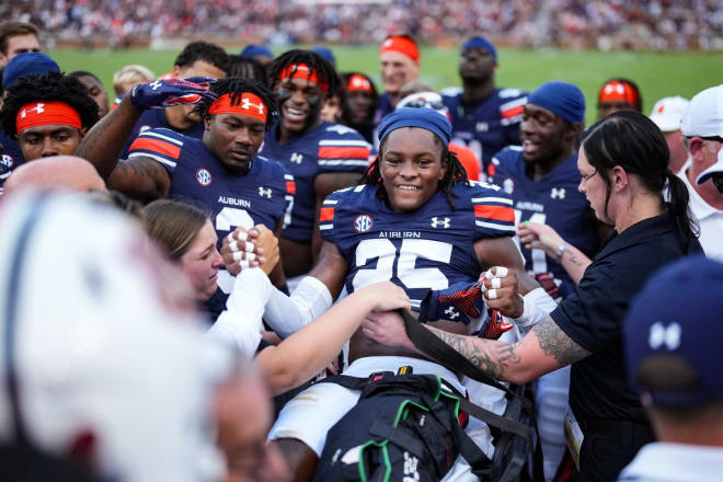 Anthony is surrounded by teammates as he's carted off the field Saturday.