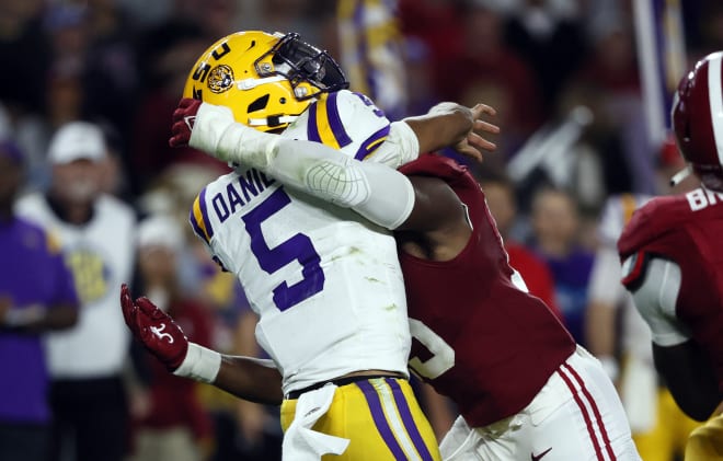 LSU Tigers quarterback Jayden Daniels (5) is hit by Alabama Crimson Tide linebacker Dallas Turner (15) as he throws the ball during the second half at Bryant-Denny Stadium. Alabama was assessed a roughing the passer penalty. Photo | Butch Dill-USA TODAY Sports