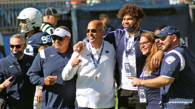 James Franklin and members of his staff pose for a photo with Mathias Barnwell and his family after the 2023 recruit picked Penn State. BWI photo/Greg Pickel