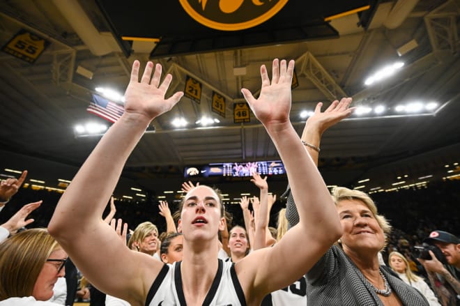 Caitlin Clark and Lisa Bluder celebrate the win over Iowa State. 