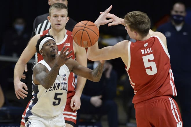 Penn State's Jamari Wheeler (5) and Wisconsin's Tyler Wahl (5) reach for the ball during the Nittany Lions' 81-71 win.