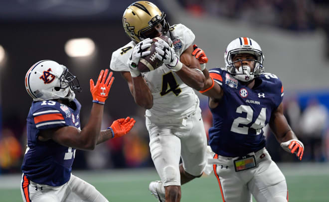 Javaris Davis (13) and Daniel Thomas (24) defend UCF receiver Tre'Quan Smith (4) during the 2018 Peach Bowl.