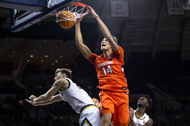 Syracuse's Jesse Edwards (14) dunks over Notre Dame's Dane Goodwin, left, in a 62-61 win for the Orange.