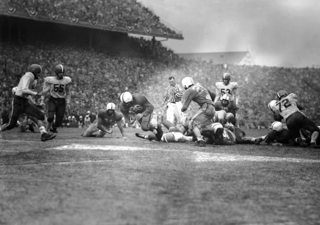 Andy Kozar (86), Tennessee fullback, plunges across the goal line with Tennessee?s winning touchdown in the Cotton Bowl game with the University of Texas in Dallas, Tex., Jan. 1, 1951. Other Tennessee players identified are tackle Kenneth Donahue (21) and back Albert Rechichar (20). No. 53 is Don Menasco, Texas linebacker. Tennessee won 20-14.