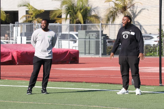 Oregon running backs coach Ra'Shaad Samples (left) and offensive line coach A'lique Terry watch Mater Dei practice on May 14.