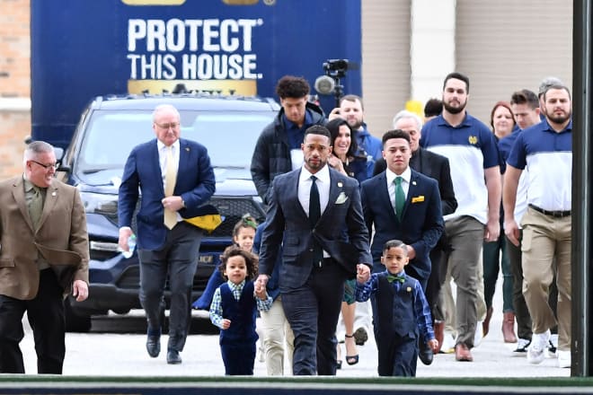 ND athletic director Jack Swarbrick follows Marcus Freeman and family into Freeman's introductory press conference Dec. 6 as Notre Dame's new head football coach.