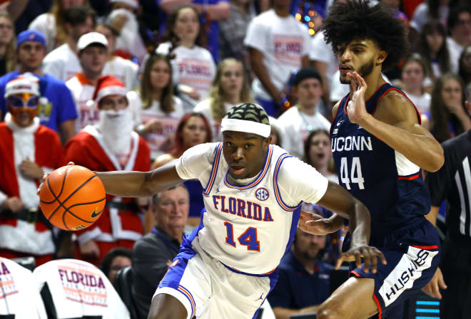 Florida Gators guard Kowacie Reeves (14) drives to the basket as Connecticut Huskies guard Andre Jackson Jr. (44) defends during the first half at Exactech Arena at the Stephen C. O'Connell Center. Photo | Kim Klement-USA TODAY Sports