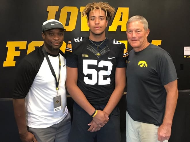 Mosai Newsome with his father, Marcus, and Iowa head coach Kirk Ferentz.