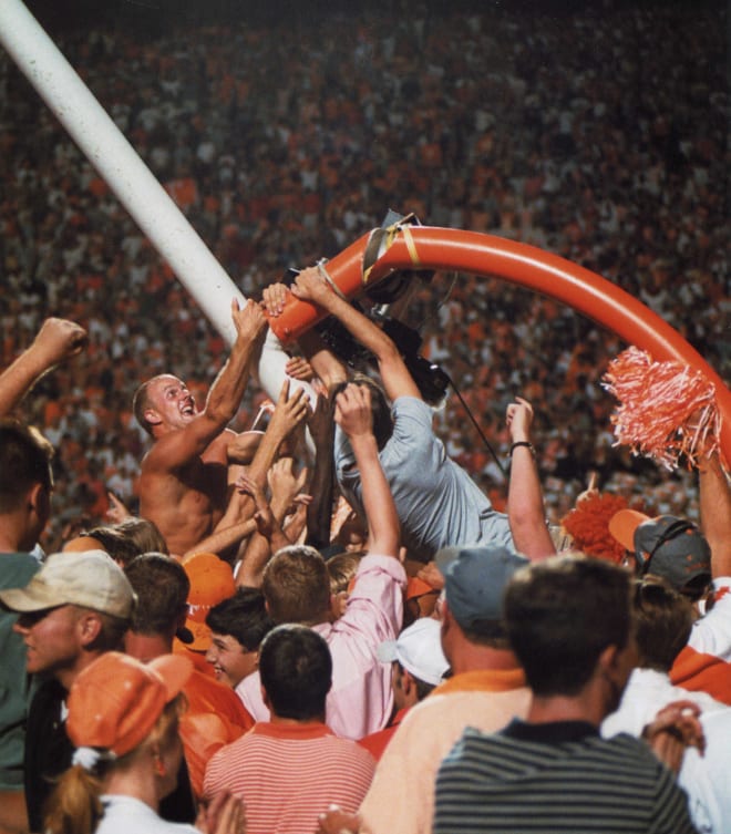 Tennessee fan Jeremy Racey climbing the downed goalpost on the field after UT beat Florida on Set. 20, 1998.Tennessee Goalpost Falling 1998