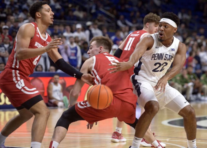 Penn State's Jalen Pickett (22) makes a bounce pass behind Wisconsin's Tyler Wahl (5) during the first half as Jordan Davis defends.