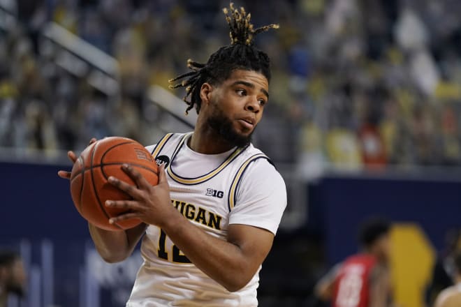 Michigan Wolverines basketball fifth-year senior guard Mike Smith hit his first three triples of the game.