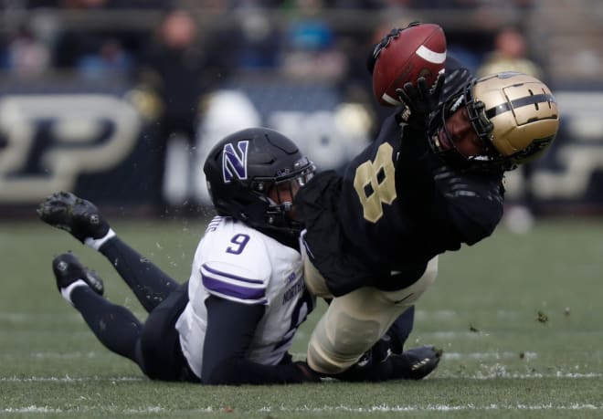 Purdue Boilermakers wide receiver TJ Sheffield (8) was tackled by Northwestern Wildcats defensive back Jeremiah Lewis (9) during the NCAA football game, Saturday, Nov. 19, 2022, at Ross-Ade Stadium in West Lafayette, Ind.