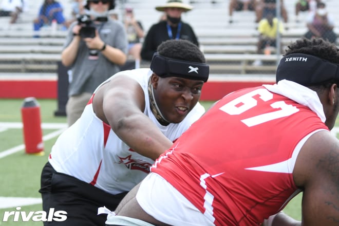 Derrell Johnson protects his "QB" during one-on-one drills at RCS Miami