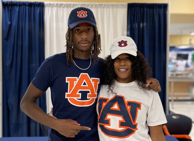 Adam Hopkins (left) and his mom (right) following his commitment.