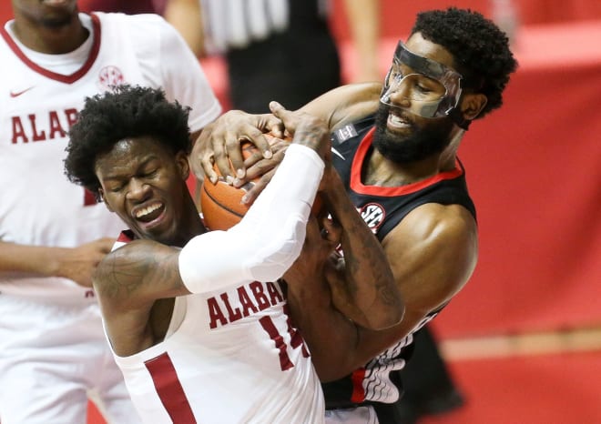 Alabama guard Keon Ellis (14) and Georgia's Andrew Garcia (4) battle for control of a rebound in Coleman Coliseum in Tuscaloosa. Photo | Imagn