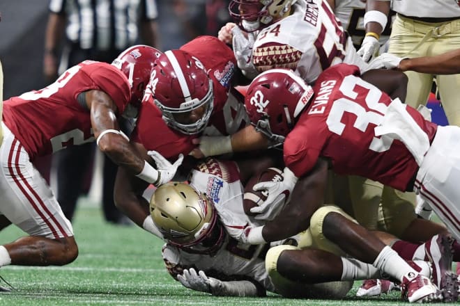 Florida State Seminoles running back Jacques Patrick (9) runs the ball against Alabama Crimson Tide defensive back Anthony Averett (28) and defensive lineman Da'Ron Payne (94) and linebacker Rashaan Evans (32) in the first quarter at Mercedes-Benz Stadium. Photo | USA Today