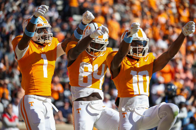 Nov 4, 2023; Knoxville, Tennessee, USA; Tennessee Volunteers wide receiver Squirrel White (10) celebrates with wide receiver Dont'e Thornton Jr. (1) and wide receiver Kaleb Webb (84) after scoring a touchdown against the Connecticut Huskies during the first half at Neyland Stadium. 