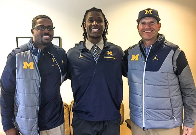 Michigan commit Luiji Vilain, flanked by Brian Smith and Jim Harbaugh, was one of many pledges and targets to receive a visit from some of Michigan's staff.