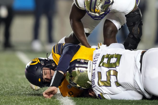 Washington Zion Tupuola-Fetui sacks Cal QB Jack Plummer in the Huskies' 28-21 win Saturday night.