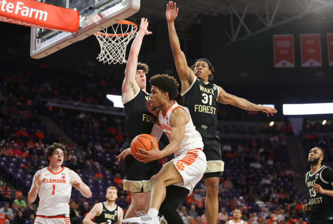 Jake LaRavia, left, and Alondes Williams defend against Clemson this past season. 