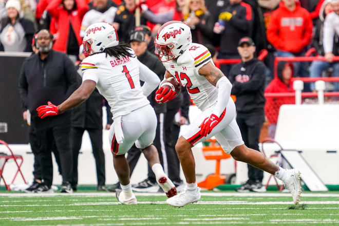 Dante Trader Jr. (No. 12) runs with the ball following one of his two interceptions at Nebraska. 