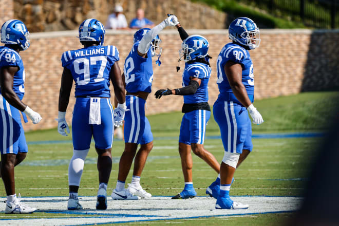 Duke's Brandon Johnson (No. 3) celebrates with linebacker Kendall Johnson during Saturday's win over Northwestern. 