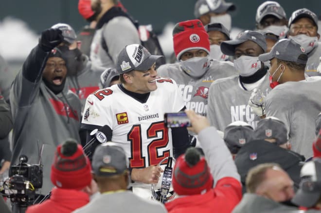 Tampa Bay Buccaneers quarterback Tom Brady (12) celebrates with teammates after defeating the Green Bay Packers during the NFC championship game Sunday, January 24, 2021, at Lambeau Field in Green Bay, Wis.