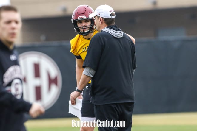 South Carolina QB Ryan Hilinski chats with offensive coordinator Mike Bobo during a Gamecocks' spring practice.