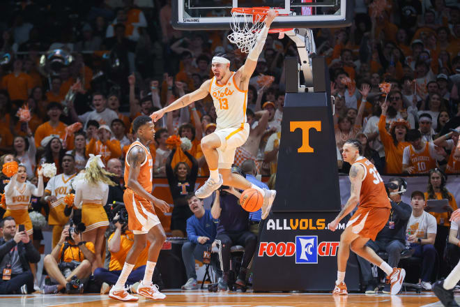 Tennessee Volunteers forward Olivier Nkamhoua (13) dunks the ball against the Texas Longhorns during the second half at Thompson-Boling Arena. Mandatory Credit: Randy Sartin-USA TODAY Sports