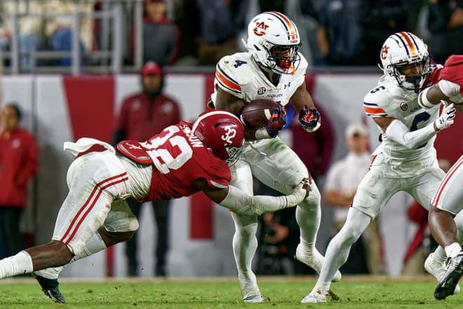 Auburn Tigers running back Tank Bigsby (4) is grabbed by Alabama Crimson Tide linebacker Deontae Lawson (32) during the second half at Bryant-Denny Stadium. Photo | Marvin Gentry-USA TODAY Sports