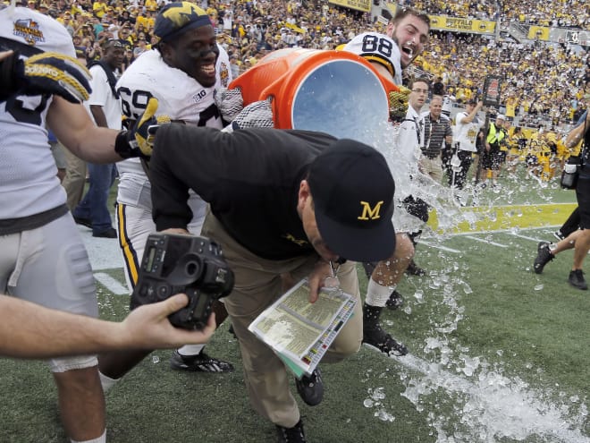 Michigan players celebrated with Jim Harbaugh after beating Florida in the Citrus Bowl.